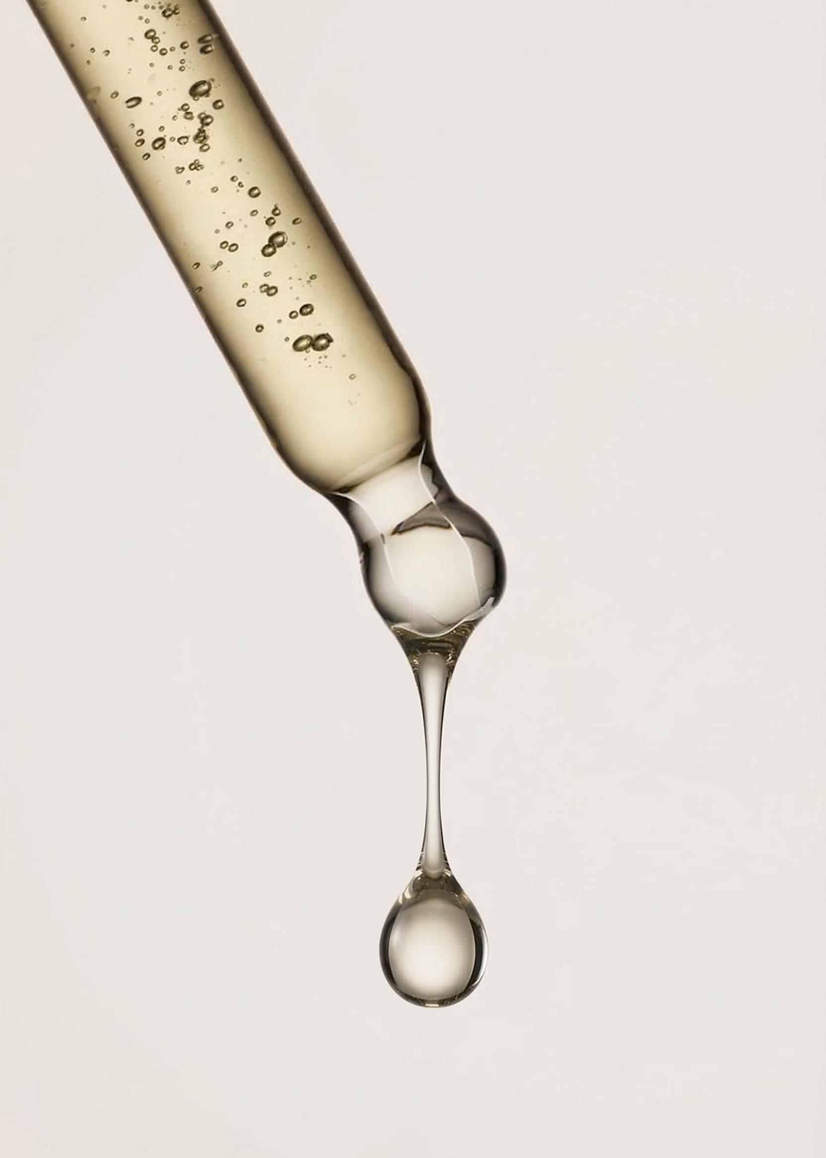 Neumina glass dropper with clear liquid droplet - cellular factories standard of purity for science-backed clean supplements